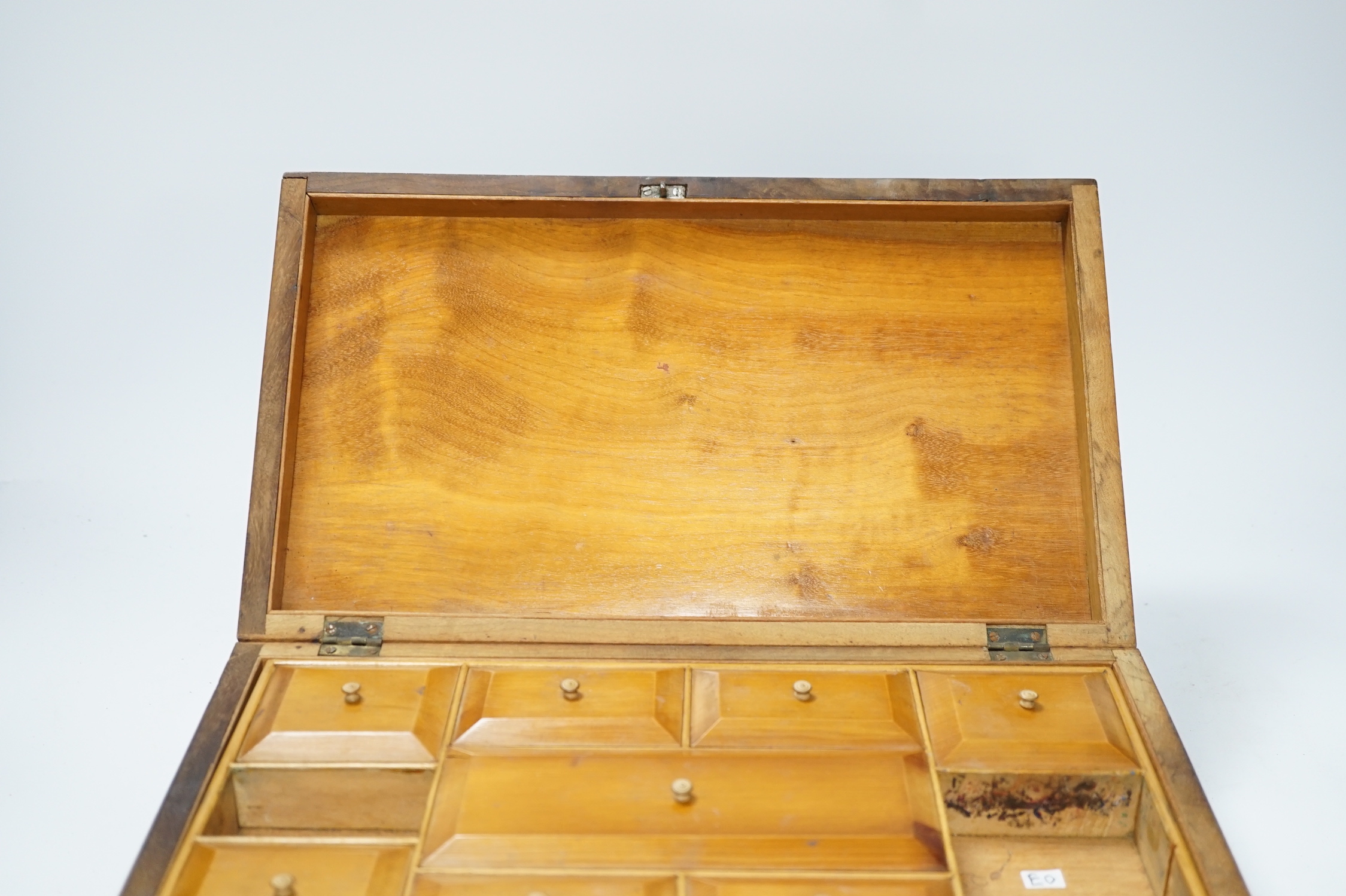 A late 19th century walnut sewing box, inlaid with a Napoleonic sea fort to a central cartouche on the lid and a fitted interior 33cm wide x10cm high